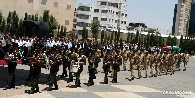 Palestinian soldiers carry the coffin of Hani al-Hassan, who was a close aide to Palestinian late leader, Yasser Arafat, during his funeral procession in the West Bank city of Ramallah on July 9, 2012. Hassan died on Jul...