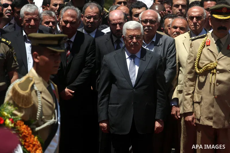 Palestinian President Mahmud Abbas attends the funeral of Hani al-Hassan, who was a close aide of Palestinian late leader, Yasser Arafat, as soldiers carry his coffin during his funeral procession in the West Bank city o...