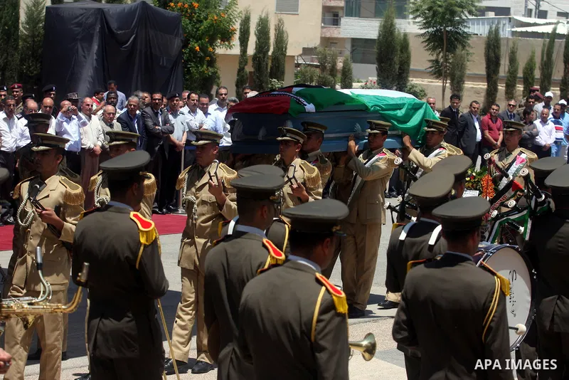 Palestinian soldiers carry the coffin of Hani al-Hassan, who was a close aide to Palestinian late leader, Yasser Arafat, during his funeral procession in the West Bank city of Ramallah on July 9, 2012. Hassan died on Jul...