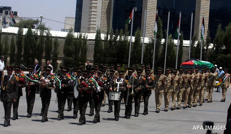 Palestinian soldiers carry the coffin of Hani al-Hassan, who was a close aide to Palestinian late leader, Yasser Arafat, during his funeral procession in the West Bank city of Ramallah on July 9, 2012. Hassan died on Jul...