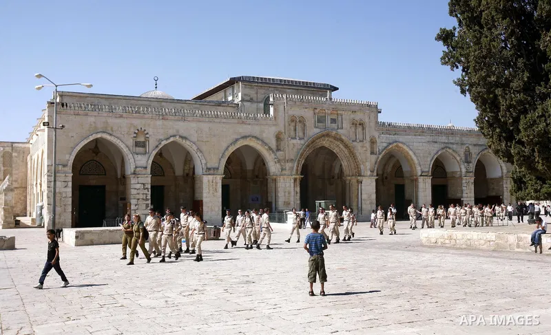 Israeli soldiers walk past the Al-Aqsa mosque compound, Islam's third holiest site, during a visit under Israeli police protection in Jerusalem's old city on July 09, 2012. Photo by Mahfouz Abu Turk