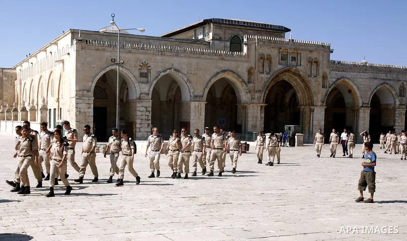 Israeli soldiers walk past the Al-Aqsa mosque compound, Islam's third holiest site, during a visit under Israeli police protection in Jerusalem's old city on July 09, 2012. Photo by Mahfouz Abu Turk