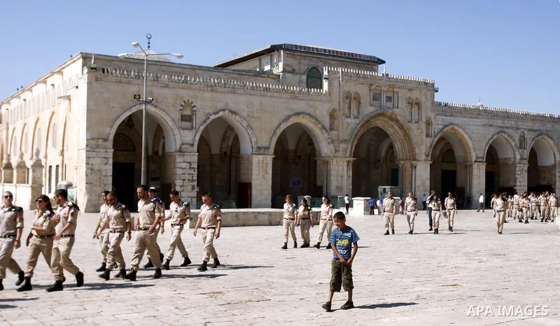 Israeli soldiers walk past the Al-Aqsa mosque compound, Islam's third holiest site, during a visit under Israeli police protection in Jerusalem's old city on July 09, 2012. Photo by Mahfouz Abu Turk