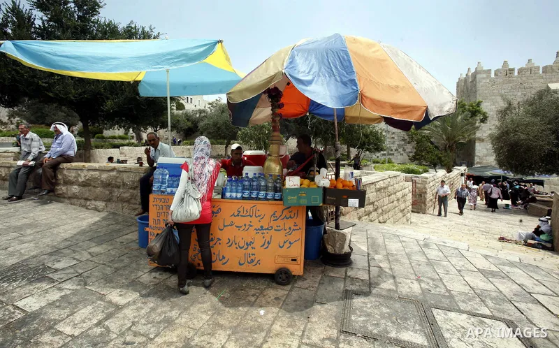 Palestinian vendor sells natural juice and drinks at the market in Jerusalem's old city on July 09, 2012. Photo by Mahfouz Abu Turk