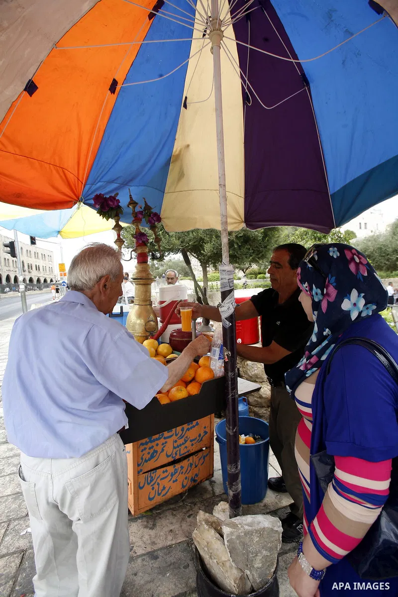 Palestinian vendor sells natural juice and drinks at the market in Jerusalem's old city on July 09, 2012. Photo by Mahfouz Abu Turk