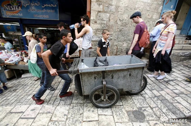 Palestinians walk at the market of Jerusalem's old city on July 09, 2012. Photo by Mahfouz Abu Turk