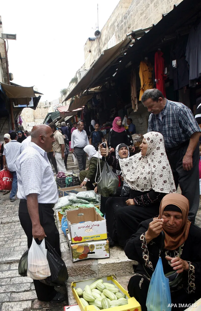 Palestinians walk at the market of Jerusalem's old city on July 09, 2012. Photo by Mahfouz Abu Turk