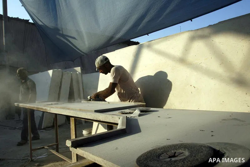 Palestinian labourers work at a marble workshop for in Rafah in southern Gaza strip on July 09, 2012. Photo by Eyad Al Baba
