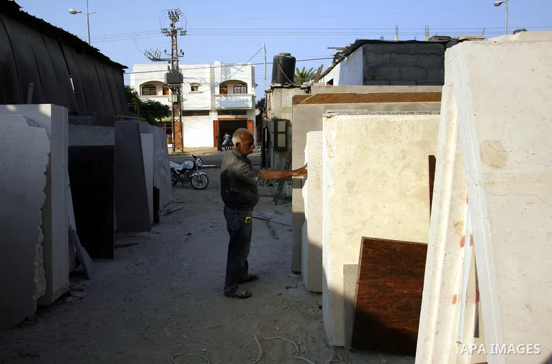 A Palestinian labourer works at a marble workshop for in Rafah in southern Gaza strip on July 09, 2012. Photo by Eyad Al Baba
