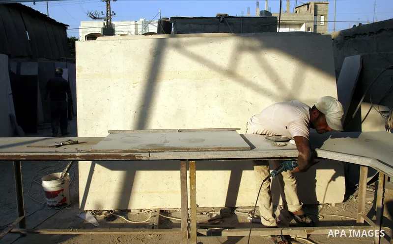 A Palestinian labourer works at a marble workshop for in Rafah in southern Gaza strip on July 09, 2012. Photo by Eyad Al Baba