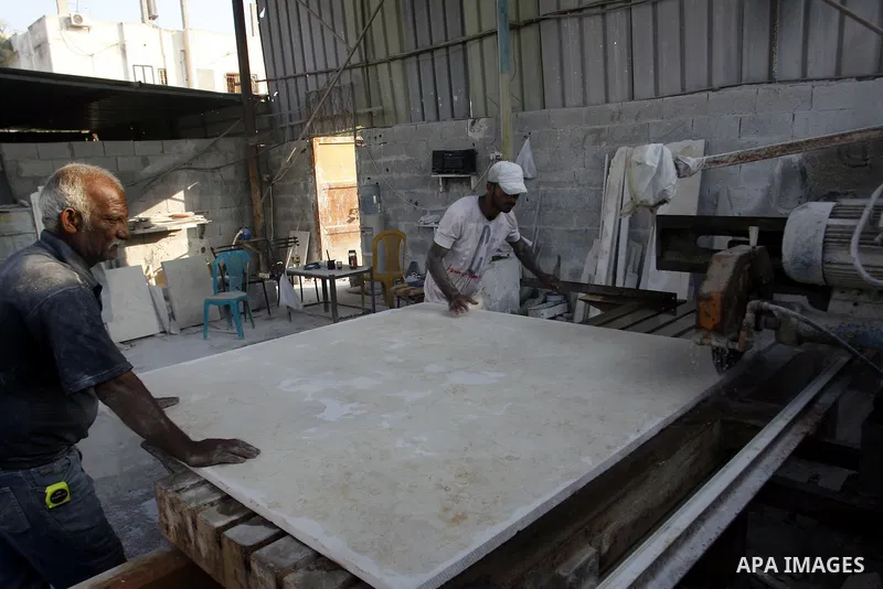 Palestinian labourers work at a marble workshop for in Rafah in southern Gaza strip on July 09, 2012. Photo by Eyad Al Baba