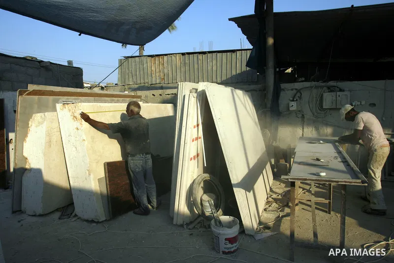 Palestinian labourers work at a marble workshop for in Rafah in southern Gaza strip on July 09, 2012. Photo by Eyad Al Baba