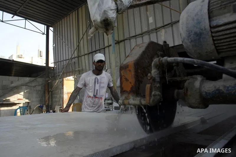 A Palestinian labourer works at a marble workshop for in Rafah in southern Gaza strip on July 09, 2012. Photo by Eyad Al Baba