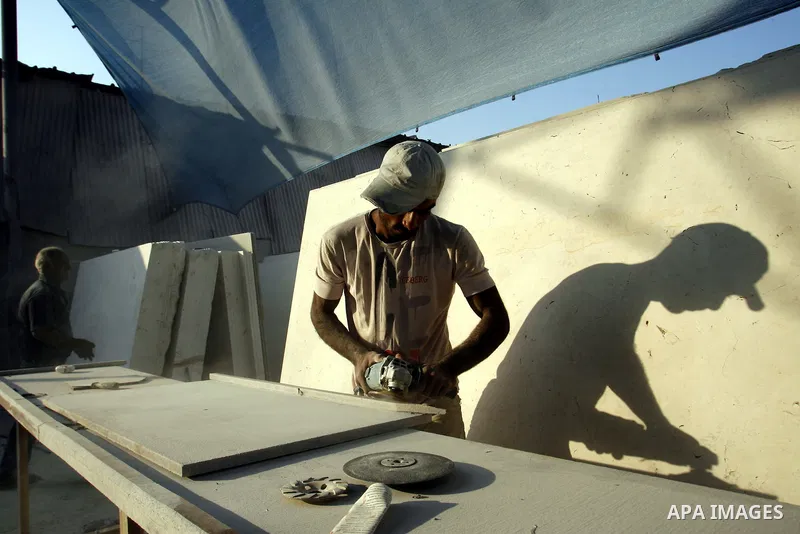 A Palestinian labourer works at a marble workshop for in Rafah in southern Gaza strip on July 09, 2012. Photo by Eyad Al Baba