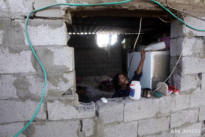 A Palestinian child takes water bottles at her home in Zeitoun neighborhood southern Gaza city on 09 July 2012. Photo by Ashraf Amra