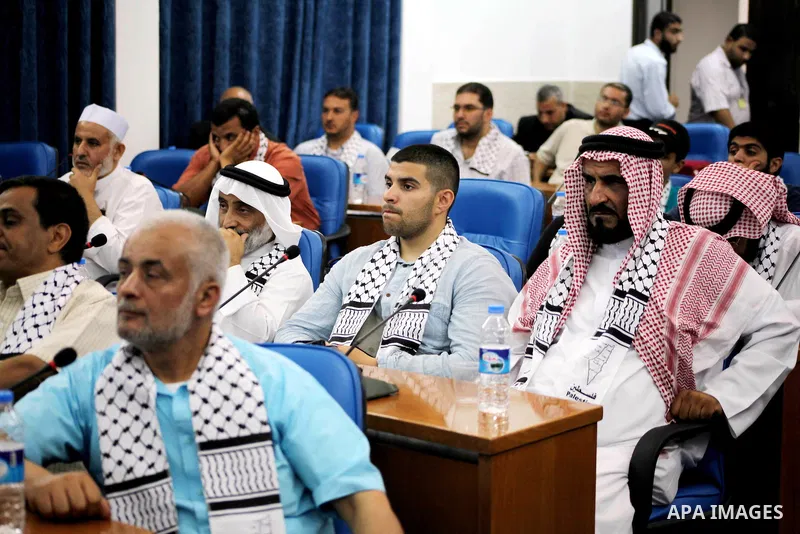 Ahmad Bahar a Hamas leader (not seen) receives members of "Miles of Smiles 14" aid convoy in Legislative Council in Gaza city on 09 July 2012. Photo by Ashraf Amra