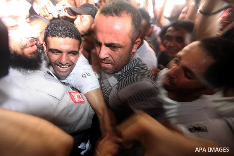 Palestinian soccer player Mahmoud Al-Sarsak waves to people upon his arrival in Gaza City July 10, 2012. Israel released the Gaza soccer player on Tuesday in a deal to end his intermittent four-month hunger strike after...