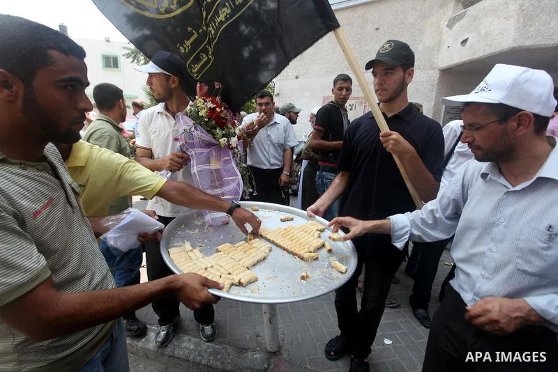 Palestinians celebrate during Palestinian soccer player Mahmoud Al-Sarsak arrives in Gaza City July 10, 2012. Israel released the Gaza soccer player on Tuesday in a deal to end his intermittent four-month hunger strike a...