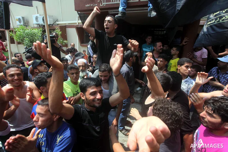Palestinians celebrate during Palestinian soccer player Mahmoud Al-Sarsak arrives in Gaza City July 10, 2012. Israel released the Gaza soccer player on Tuesday in a deal to end his intermittent four-month hunger strike a...