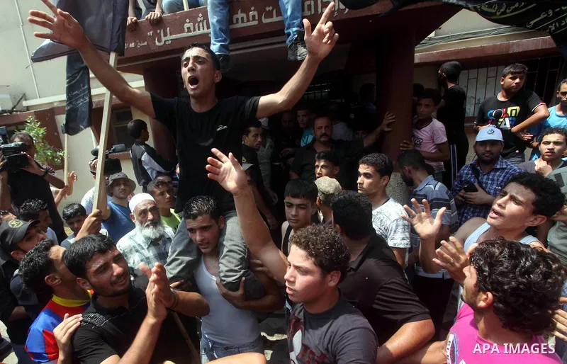 Palestinians celebrate during Palestinian soccer player Mahmoud Al-Sarsak arrives in Gaza City July 10, 2012. Israel released the Gaza soccer player on Tuesday in a deal to end his intermittent four-month hunger strike a...