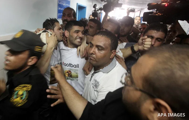Palestinian soccer player Mahmoud Al-Sarsak waves to people upon his arrival in Gaza City July 10, 2012. Israel released the Gaza soccer player on Tuesday in a deal to end his intermittent four-month hunger strike after...