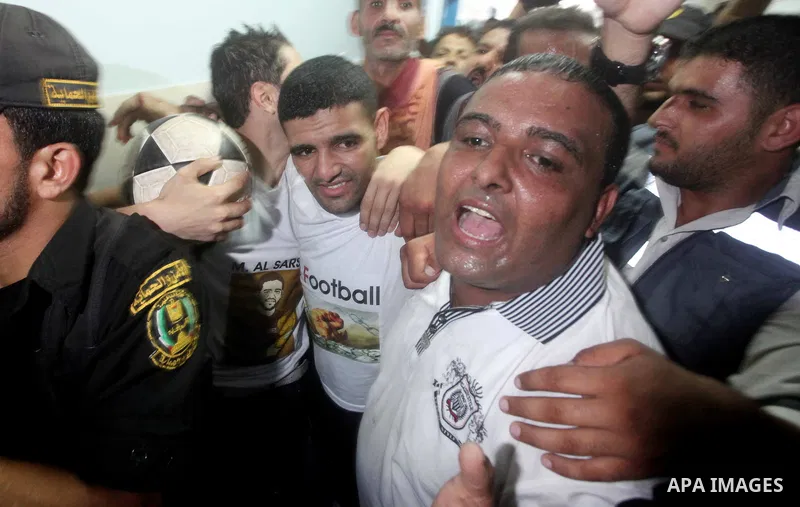 Palestinian soccer player Mahmoud Al-Sarsak waves to people upon his arrival in Gaza City July 10, 2012. Israel released the Gaza soccer player on Tuesday in a deal to end his intermittent four-month hunger strike after...