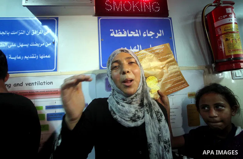 Palestinian woman reacts while Palestinian soccer player Mahmoud Al-Sarsak arrives in Gaza City July 10, 2012. Israel released the Gaza soccer player on Tuesday in a deal to end his intermittent four-month hunger strike...