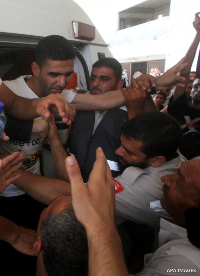Palestinian soccer player Mahmoud Al-Sarsak waves to people upon his arrival in Gaza City July 10, 2012. Israel released the Gaza soccer player on Tuesday in a deal to end his intermittent four-month hunger strike after...