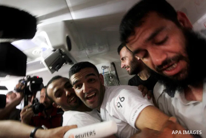 Palestinian soccer player Mahmoud Al-Sarsak greets people upon his arrival in Gaza City July 10, 2012. Israel released the Gaza soccer player on Tuesday in a deal to end his intermittent four-month hunger strike after he...