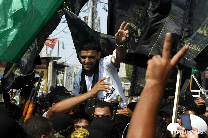 Palestinian soccer player Mahmud Sarsak who staged a hunger strike of nearly three months while in Israeli jail, flashes the V for "victory" sign as he arrives to Rafah southern Gaza strip on July 10, 2012 upon his relea...