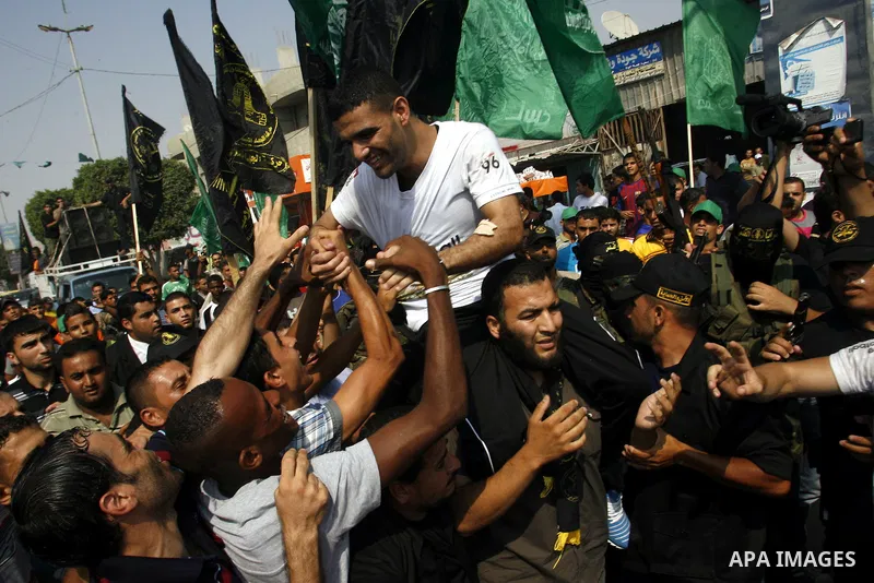 Palestinian soccer player Mahmoud Al-Sarsak greets people upon his arrival to Rafah southern Gaza strip, July 10, 2012. Israel released the Gaza soccer player on Tuesday in a deal to end his intermittent four-month hunge...