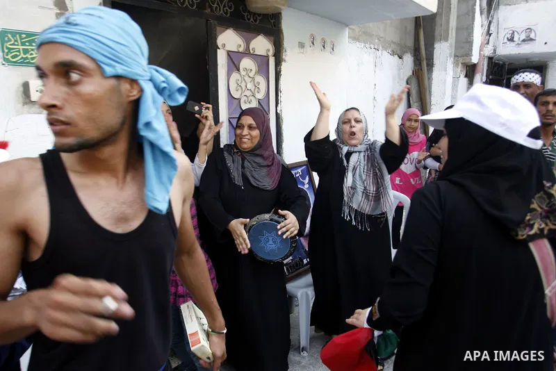 The family of Palestinian prisoner Mahmud Al-Sarsak celebrate in font of his home, as he arrives to Rafah southern Gaza strip on July 10, 2012 upon his release from Israeli prison. Sarsak staged a hunger strike of nearly...