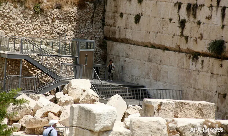 A tourists stands at an excavation site of an ancient places near al-Aqsa Mosque and Western Wall, in Jerusalem's old city on 10 July 2012. The excavation in order to Judaize the area. Photo by Mahfouz Abu Turk