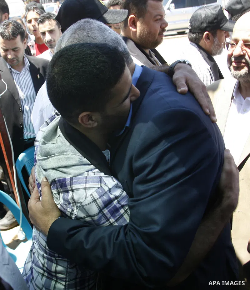 Palestinian Prime Minister in the Gaza Strip, Ismail Haniyeh meets with Palestinian football player Mahmud Sarsak, who staged a hunger strike of nearly three months while in Israeli jail, in the southern Gaza Strip on Ju...