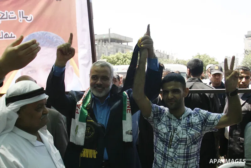 Palestinian Prime Minister in the Gaza Strip, Ismail Haniyeh meets with Palestinian football player Mahmud Sarsak, who staged a hunger strike of nearly three months while in Israeli jail, in the southern Gaza Strip on Ju...