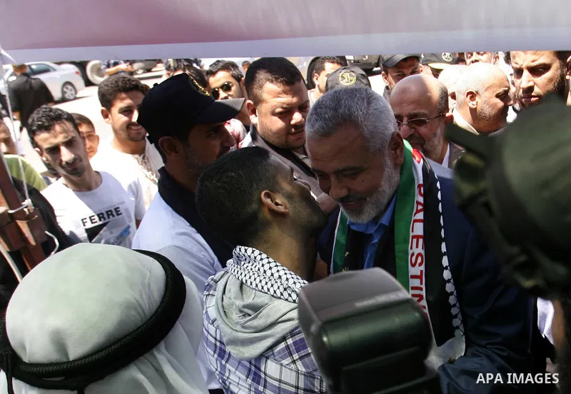 Palestinian Prime Minister in the Gaza Strip, Ismail Haniyeh meets with Palestinian football player Mahmud Sarsak, who staged a hunger strike of nearly three months while in Israeli jail, in the southern Gaza Strip on Ju...