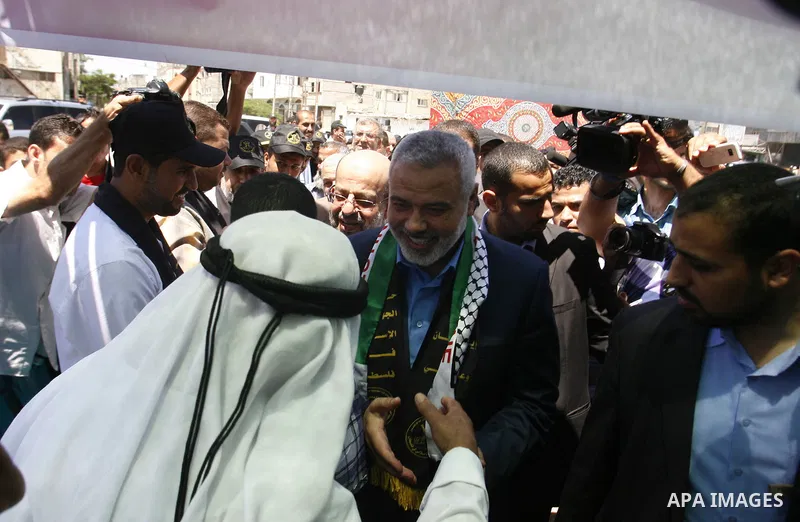 Palestinian Prime Minister in the Gaza Strip, Ismail Haniyeh meets with Palestinian football player Mahmud Sarsak, who staged a hunger strike of nearly three months while in Israeli jail, in the southern Gaza Strip on Ju...