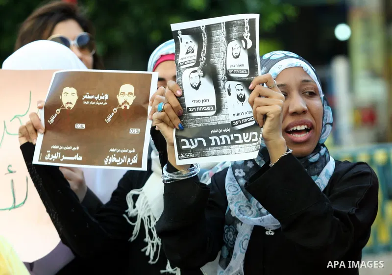 Palestinian protestors hold pictures of Palestinian prisoners in Israeli jails whose are still refusing food for after a deal was made to end a mass prisoner hunger strike, during a demonstration in their support, in the...