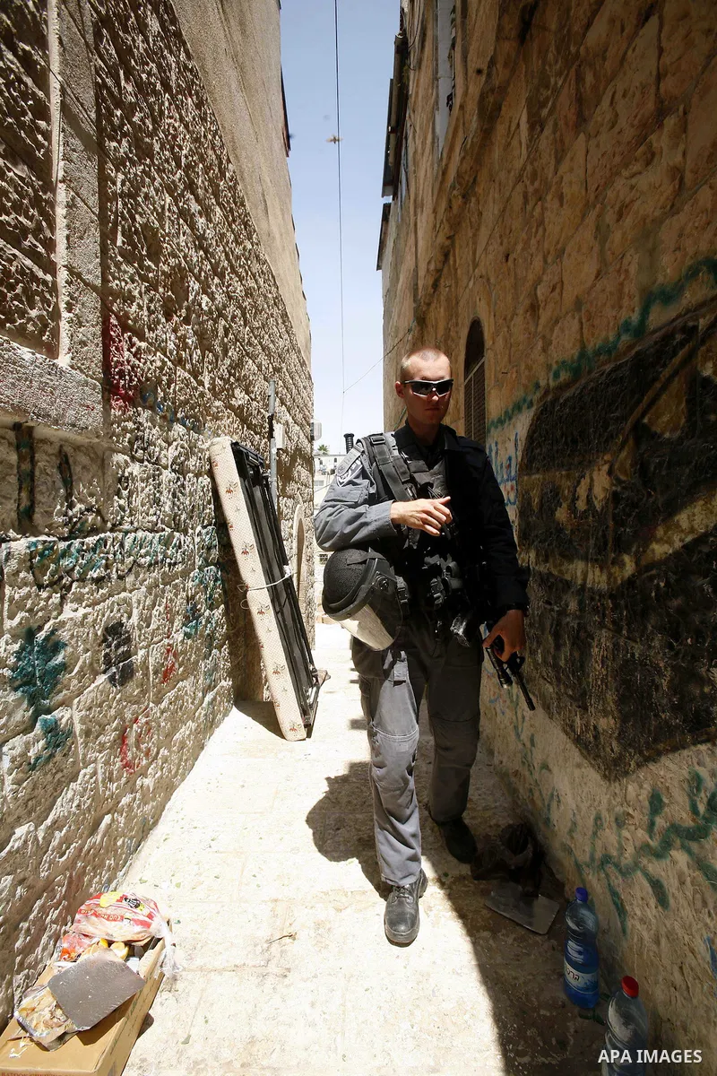Israeli police officers oversight evacuation process of a Palestinian house in Jerusalem's old city on July. 11,2012 after the Palestinian family receive a notification to evacuate their house. Photo by Mahfouz Abu Turk