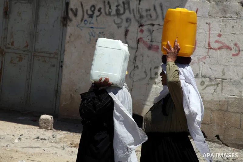 Palestinian women carry their bottles a potable water from a water purification station, in Deir al-Balah central Gaza Strip, on July 11. 2012. Palestinians suffer from the severe lack of potable water. Photo by Ashraf A...