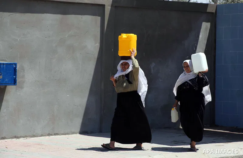 Palestinian women carry their bottles a potable water from a water purification station, in Deir al-Balah central Gaza Strip, on July 11. 2012. Palestinians suffer from the severe lack of potable water. Photo by Ashraf A...