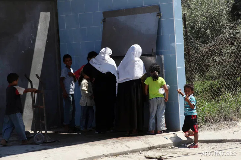 Palestinian women fill their bottles a potable water at a water purification station, in Deir al-Balah central Gaza Strip, on July 11. 2012. Palestinians suffer from the severe lack of potable water. Photo by Ashraf Amra