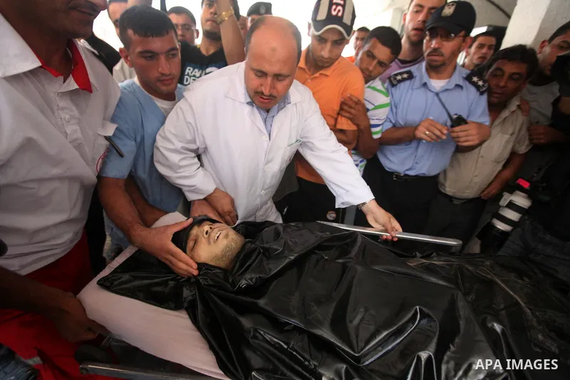 Palestinian medics wheel a Hamas militant into al-Shifa Hospital following an Israeli attack in Gaza City on July 12, 2012. A Palestinian militant from the ruling Hamas movement was killed and two others wounded on Thurs...