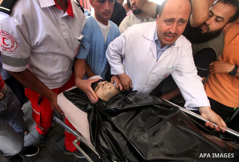 Palestinian medics wheel a Hamas militant into al-Shifa Hospital following an Israeli attack in Gaza City on July 12, 2012. A Palestinian militant from the ruling Hamas movement was killed and two others wounded on Thurs...