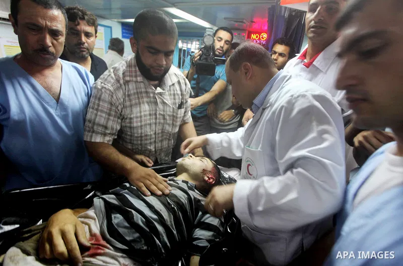 Palestinian medics wheel a Hamas militant into al-Shifa Hospital following an Israeli attack in Gaza City on July 12, 2012. A Palestinian militant from the ruling Hamas movement was killed and two others wounded on Thurs...