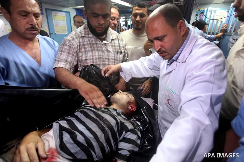 Palestinian medics wheel a Hamas militant into al-Shifa Hospital following an Israeli attack in Gaza City on July 12, 2012. A Palestinian militant from the ruling Hamas movement was killed and two others wounded on Thurs...