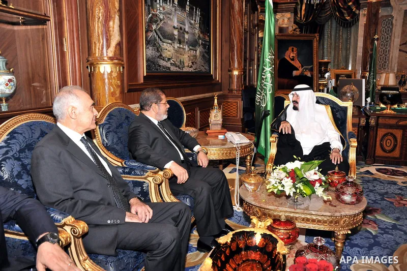 Saudi Arabia's King Abdullah bin Abdul Aziz (R) with Egypt's President Mohamed Morsi (C) and Foreign Minister Kamel Amr (L) during their meeting in Jeddah, Saudi Arabia, 11 July 2012. Egyptian President Morsi arrived 11...