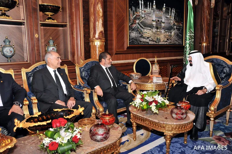 Saudi Arabia's King Abdullah bin Abdul Aziz (R) with Egypt's President Mohamed Morsi (C) and Foreign Minister Kamel Amr (L) during their meeting in Jeddah, Saudi Arabia, 11 July 2012. Egyptian President Morsi arrived 11...