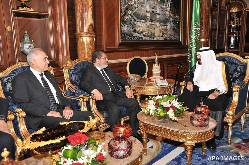 Saudi Arabia's King Abdullah bin Abdul Aziz (R) with Egypt's President Mohamed Morsi (C) and Foreign Minister Kamel Amr (L) during their meeting in Jeddah, Saudi Arabia, 11 July 2012. Egyptian President Morsi arrived 11...