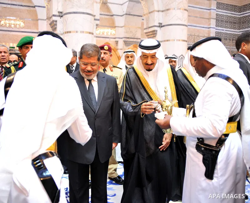Egypt's President Mohamed Morsi (L) and Saudi Arabia Crown Prince Salman bin Abdul-Aziz Al Saud (R) being welcomed with a traditional arabic coffee in Jeddah, Saudi Arabia, late 11 July 2012. Egyptian President arrived 1...